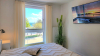 Schlafzimmer 1 mit Doppelbett, TV und Ostseeblick